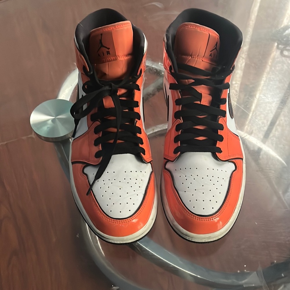 Orange black and white Jordan 1s